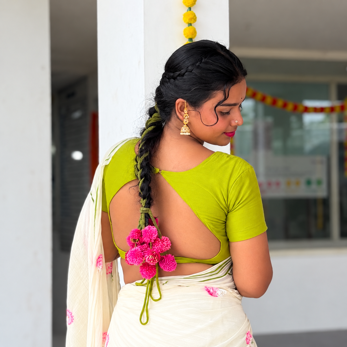 Woman in Kerala saree with Kunjalam braid adornment — handcrafted Kerala hair accessory by KANAV