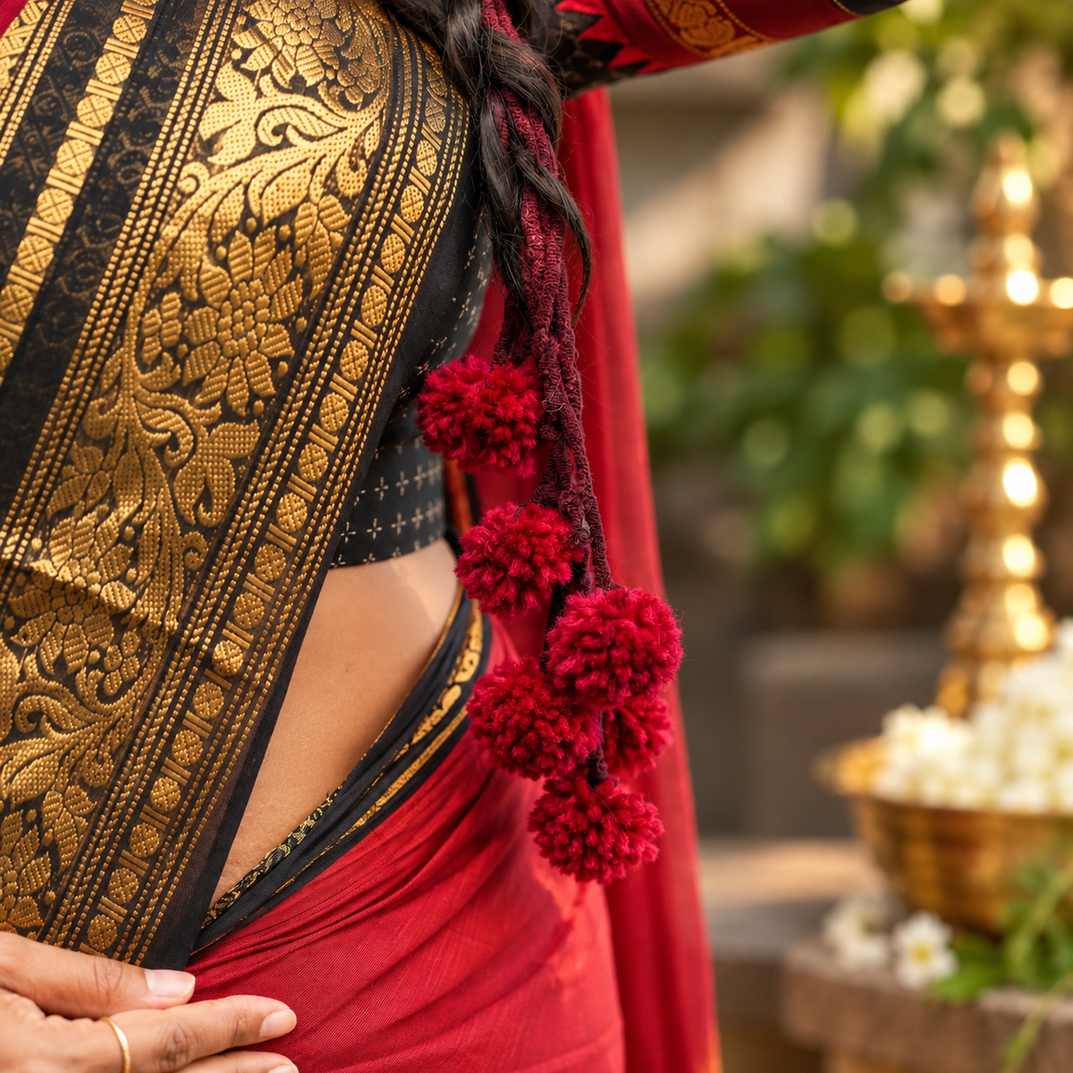 Close-up of Maroon Chocolate Kerala Parandi heritage hair jewellery for brides
