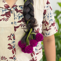Vadamalli flower Kerala Parandi hair accessory in pink and purple for South Indian bridal styling
