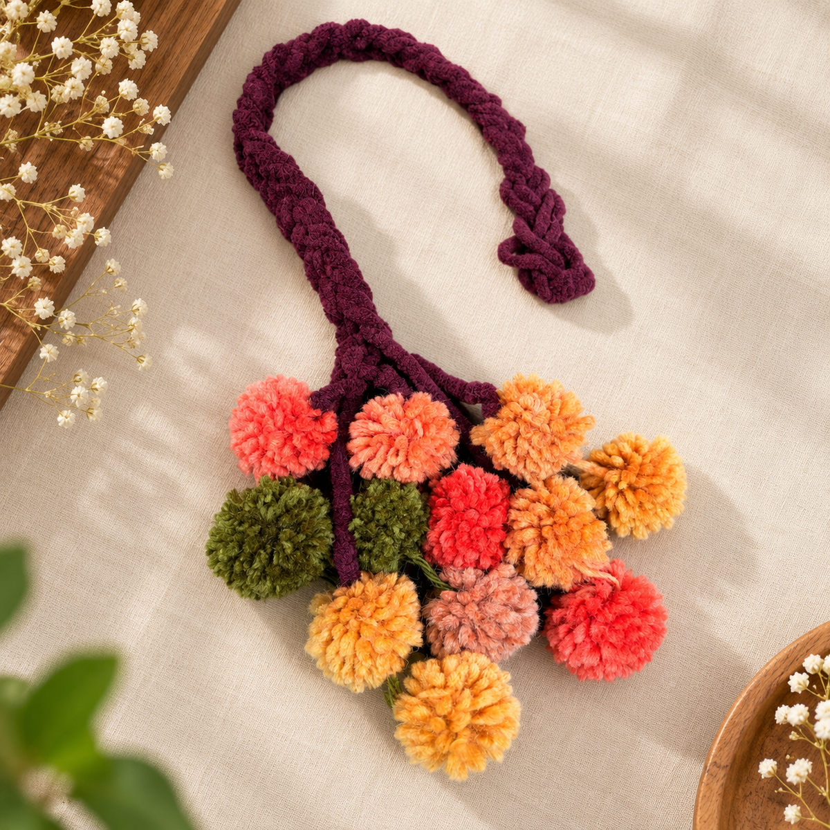 Close-up of Jamanthi Kerala Parandi traditional braid jewellery in yellow tones
