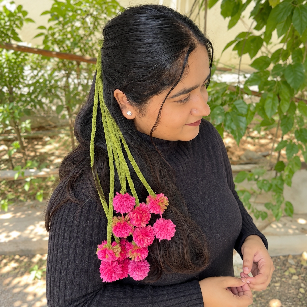 Bougainvillea Kerala Kunjalam hair accessory styled on braid with vibrant pink tassels
